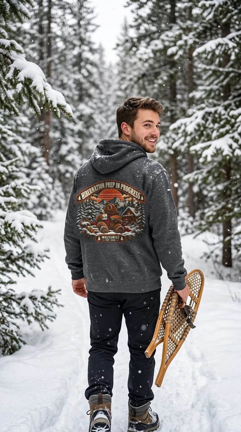 Man wearing the Hibernation Prep hoodie on a snowy trail